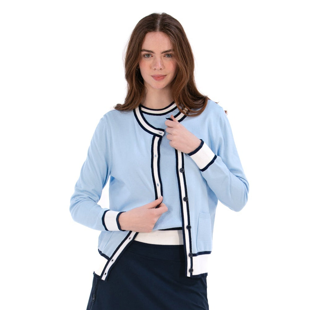 Woman wearing a light blue cardigan over a black and white striped shirt with a navy skirt on a white background